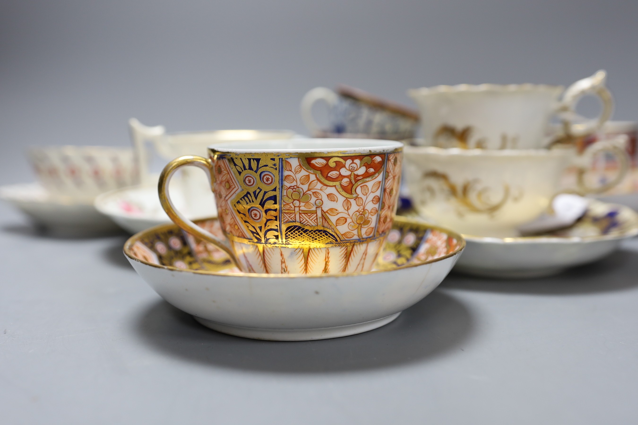 A Spode Imari pattern coffee can and saucer, a Coalport Imari cup and saucer, a Coalport style floral trio, a Worcester Royal Lily trio, a Flight teabowl and saucer and an English rose painted cup and saucer